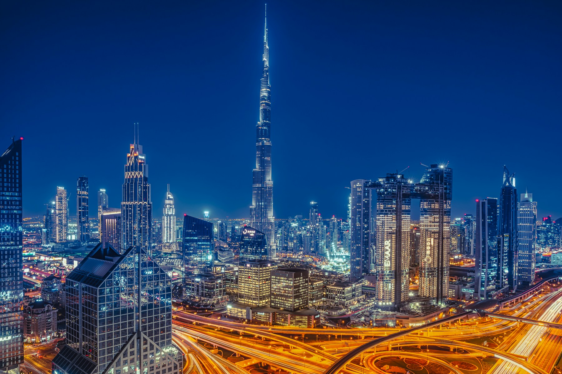 Dubai skyline at night with the Burj Khalifa and illuminated highways